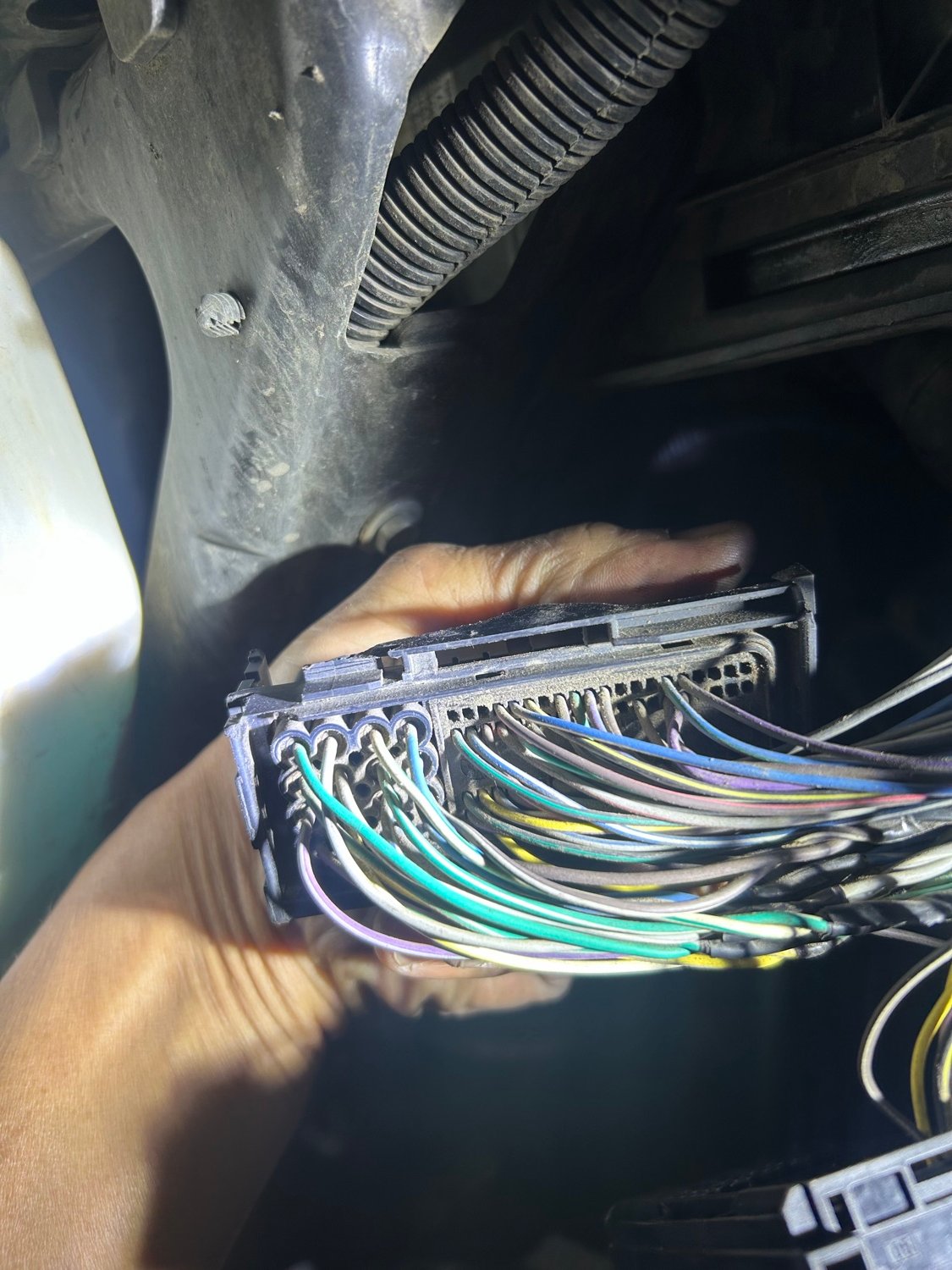 Technician working on engine wiring harness